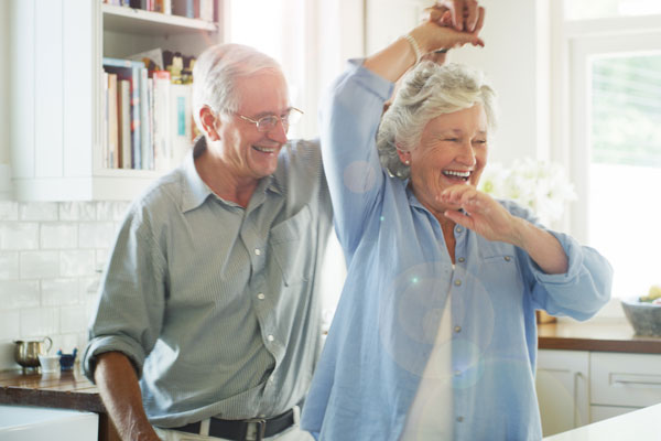 elderly couple dances happily