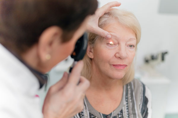 an elderly woman getting an eye exam