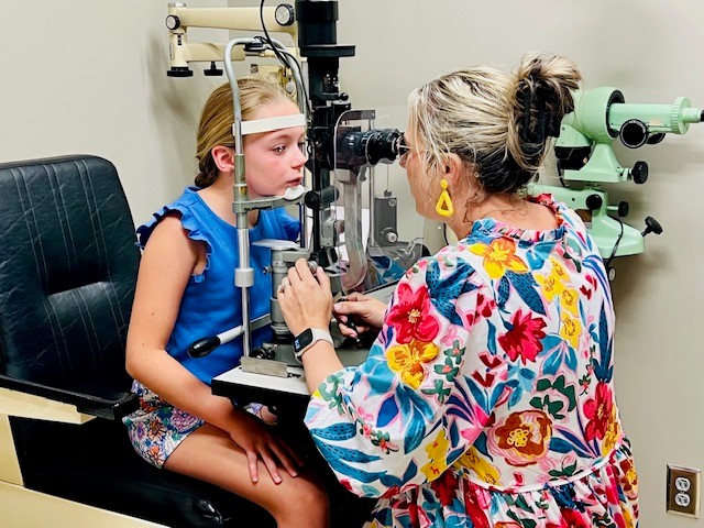 Young girl being examined by a Vision Eye Group optician