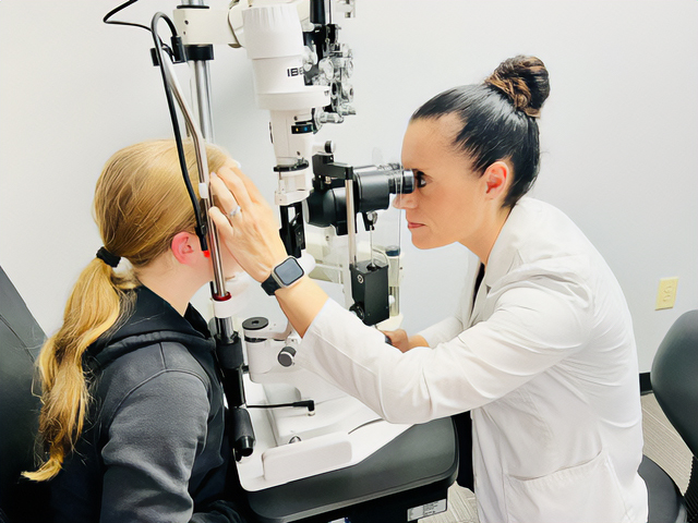 Dr. Misti Smith performs an eye exam on a patient.